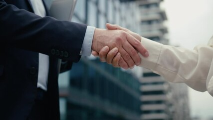 Two business people handshaking meeting in city businessman handshake with businesswoman partners diversity multiracial shaking hands cooperation man woman welcome hiring partnership success deal - Powered by Adobe