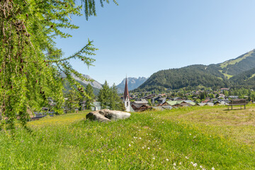 31 may 2025, Seefeld, Austria. View on Seefeld in Tirol village with church and houses. Mountains...