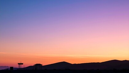 Obraz premium Crisp silhouette of distant minimal forms under a saturated twilight gradient sky, blending magenta, plum, and gold