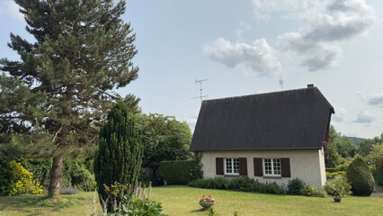 House with Dark Roof and Green Lawn