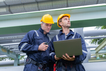 Engineers Analyzing Industrial Piping System Onsite