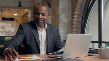 African American middle-aged entrepreneur typing laptop computer business man office businessman...