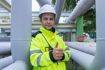 Engineers Analyzing Industrial Piping System Onsite