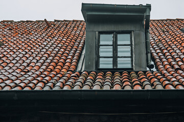 Red Clay Tile Roof with Weathered Dormer Window