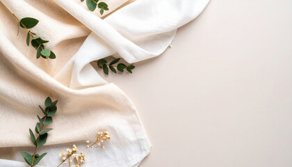 Soft linen fabric with eucalyptus leaves and delicate flowers on neutral background