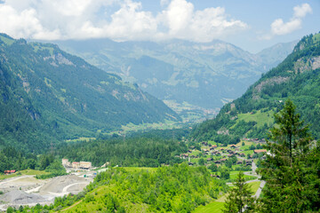 Obraz premium Scenic view of alpine mountain panorama at village of Kandersteg on a sunny spring afternoon. Photo taken June 19th, 2025, Kandersteg, Switzerland. 