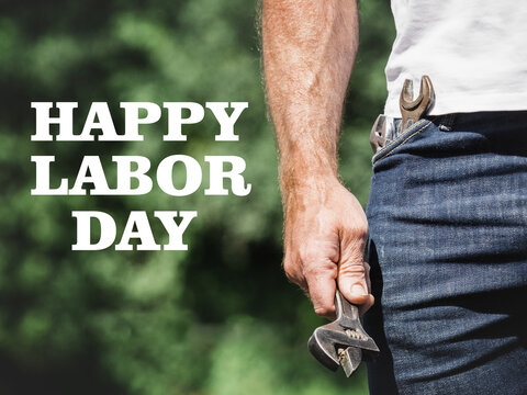 Happy Labor Day. Handsome man and hand tools. Closeup, outdoors. Congratulations for family, loved ones, friends and colleagues. Concept of preparation for the national holiday