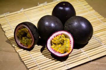 Fresh Purple Passion Fruits Displayed on a Bamboo Matting Surface