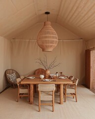 Dining area of a traditional Bedouin tent house that fuses ancient architecture with minimalism designed in a muted camel and ochre theme
