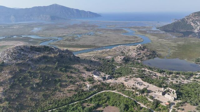 View from acropolis on top of mount to famous ancient Greek city Kaunos in Caria or Caunus in Roman period in Anatolia. Popular place for family travel on summer vacation. Dalyan, Mugla, Turkey
