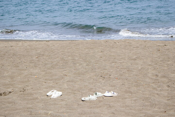 White Sandals on Summer Beach Shoreline
