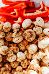 Mushrooms and red bell peppers seasoned and ready for grilling at a summer barbecue gathering
