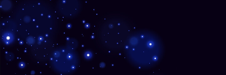 Blue glowing particles on dark background with soft bokeh light effect and dreamy cosmic atmosphere