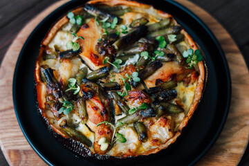 Delicious vegetable quiche prepared with fresh ingredients beans meat in a rustic kitchen setting