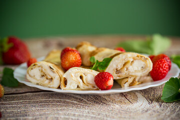 Pancakes with cottage cheese and strawberries for breakfast