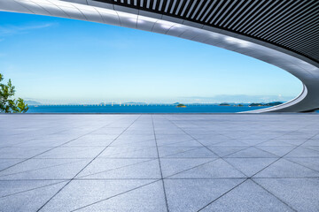 Empty square floor and bridge with blue sea scenery under blue sky