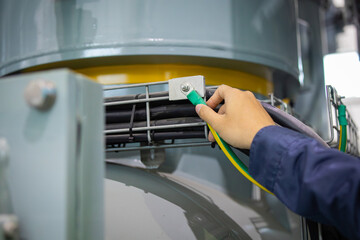 Substation engineer inspects gas insulated switchgear with careful attention to ensure safety and...