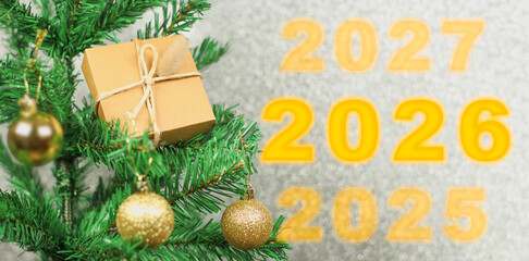 Happy New Year 2026 anniversary. Transition from 2025 to new year 2026 concept image with golden ball ornament on Christmas tree.