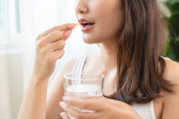 person prepare fish oil pills to her hands taking daily supplement