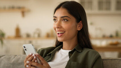 Happy smiling positive amazed wonder surprised Indian woman Arabian female ethnic girl browsing...