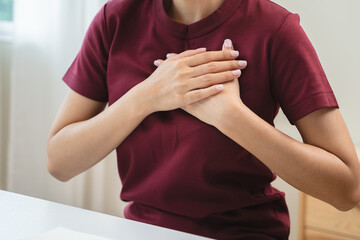 Close-up woman touching chest feeling pain heart attack symptom
