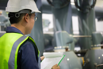 Engineer inspects gas insulated switchgear equipment in substation ensuring safety and operational...