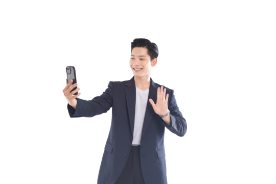 Asian businessman typing message, calm expression in modern office