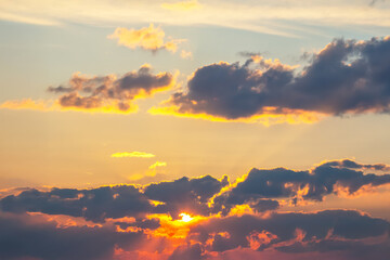 Dynamic sky with towering dark clouds and brilliant sunlight rays cutting through. A breathtaking natural display, ideal for landscapes, weather studies, and artistic or cinematic use.
