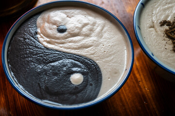 Bowls of black sesame and almond sweet soup create a Yin and Yang. A common Tangyuan dessert served during festivals symbolizes harmony and balance in life.