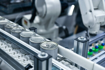 Canned food products on conveyor belt in distribution warehouse.food transportation system concept