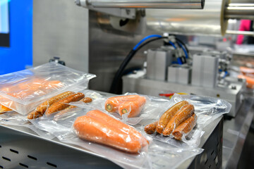 High-performance machines are wrapping food products food in production lines on conveyor belts, food production industry