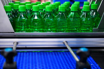 Green plastic Bottles transfer on Automated conveyor systems industrial automation for package