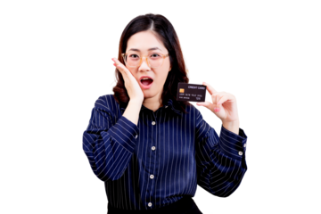 A surprised Asian young beautiful woman wearing glasses holds up a credit card with one hand while her other hand touches her cheek.