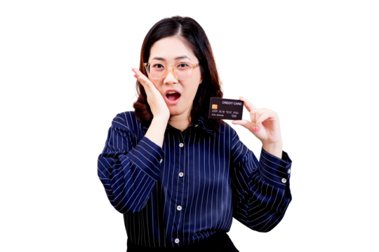 A surprised Asian young beautiful woman wearing glasses holds up a credit card with one hand while her other hand touches her cheek.