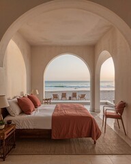 Sleeping area of a Moroccan riad style house that fuses ancient architecture with minimalism in front of beach designed in a soft sand and sunset rose theme
