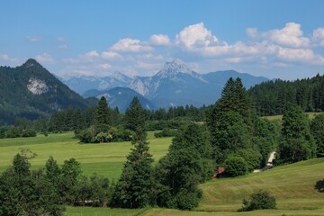 Scenic mountain landscape in the Füssen region of Germany featuring lush greenery and majestic...