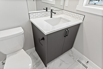 Bathroom with a white sink and a black toilet
