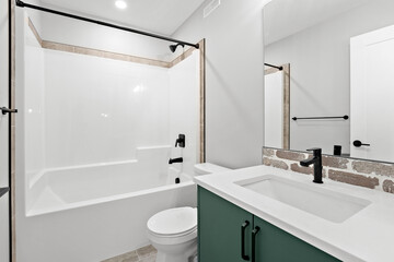 Bathroom with a white toilet and sink, and a green cabinet