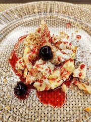 Dessert with cream and sour cherries, served in an Italian restaurant.