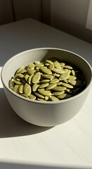Sunlit Bowl of Green Pumpkin Seeds