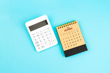 December 2026 brown caculator and white calculator on blue color background.