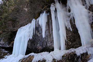 March 2025: Frozen waterfall in Val di Fassa, Dolomites a majestic winter scene where ice cascades down the rock face like crystal. Perfect for alpine and nature lovers.