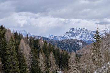 Obraz premium March 2025: winter landscape at Ski Area in Dolomites, Italy - Alpe Lusia. Ski resort in val di Fassa near Moena. Winter Dolomites and blue sky. Aerial view on ski slopes