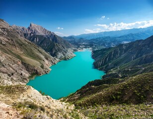 Fototapeta premium an eye catching top down view of a bright blue lake in the middle of mountains