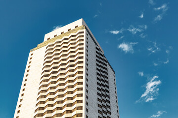 Tall modern residential apartment tower under blue sky in Izmir, Turkey