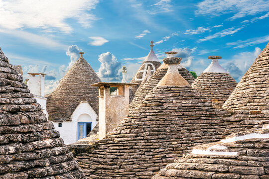 Beautiful trulli buildings in Alberobello, Italia. Conic tile roofs of trulli near Bari in Italy. Mediterranean architacture in touristic town