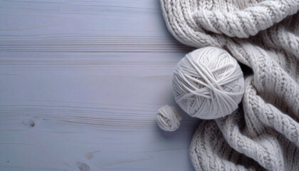 Knitting wool yarn balls in on a wooden table with copy space. Cozy knitting scene with warm texture, ideal for craft, handmade, or winter-themed designs.
