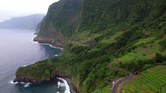 Madeiar island scenery. aerial drone view of beautiful coast and village Seixal with winding road and tunels. Portugal tourism