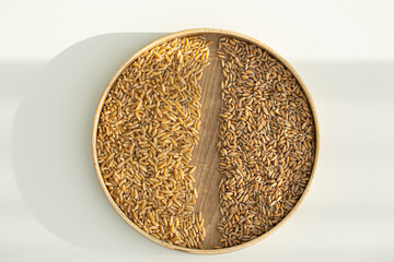 Heap of kamut kernels on white background