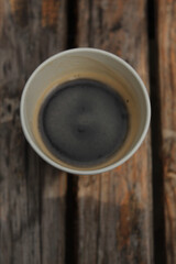 Cappuccino cups with cherry pie and cookies served on a black table in a cozy caf&eacute;. Warm tones and sweet dessert moment.